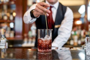 Bartender mixing a cocktail at a bar in Sydney