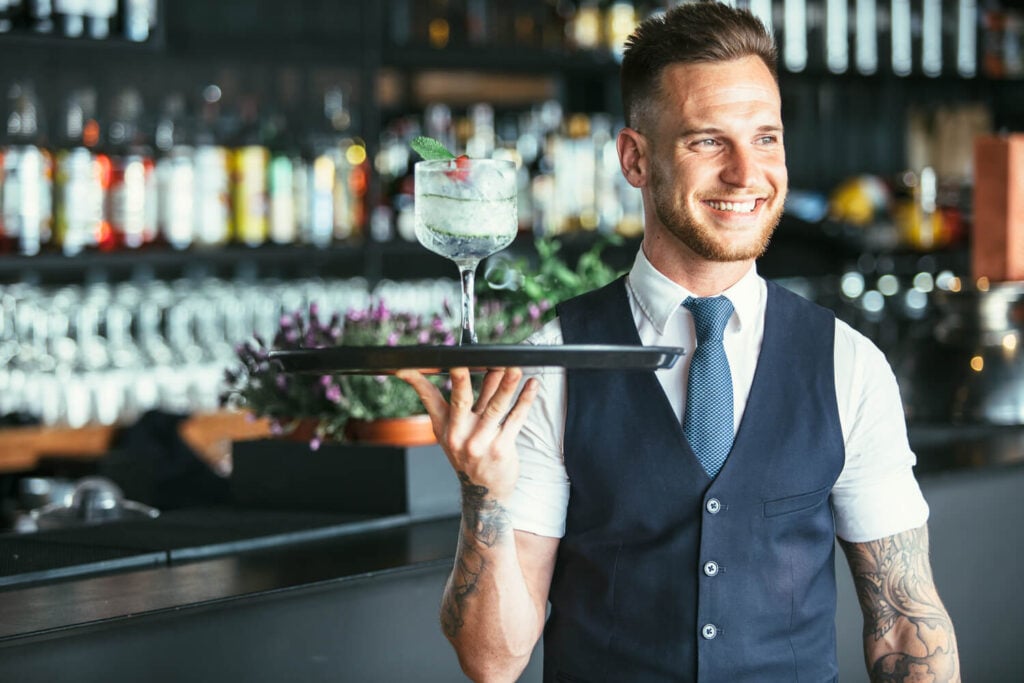 Bartender serving a cocktail at a licensed venue in Sydney