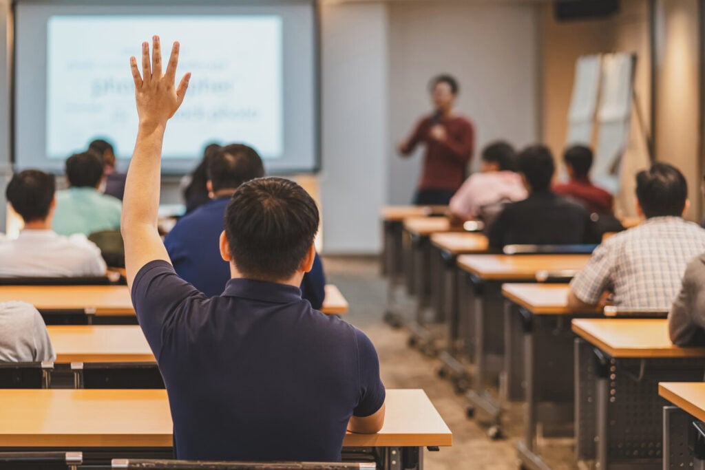 Student Raising Hand During a Classroom Lecture