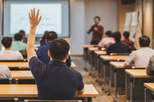 Student Raising Hand During a Classroom Lecture