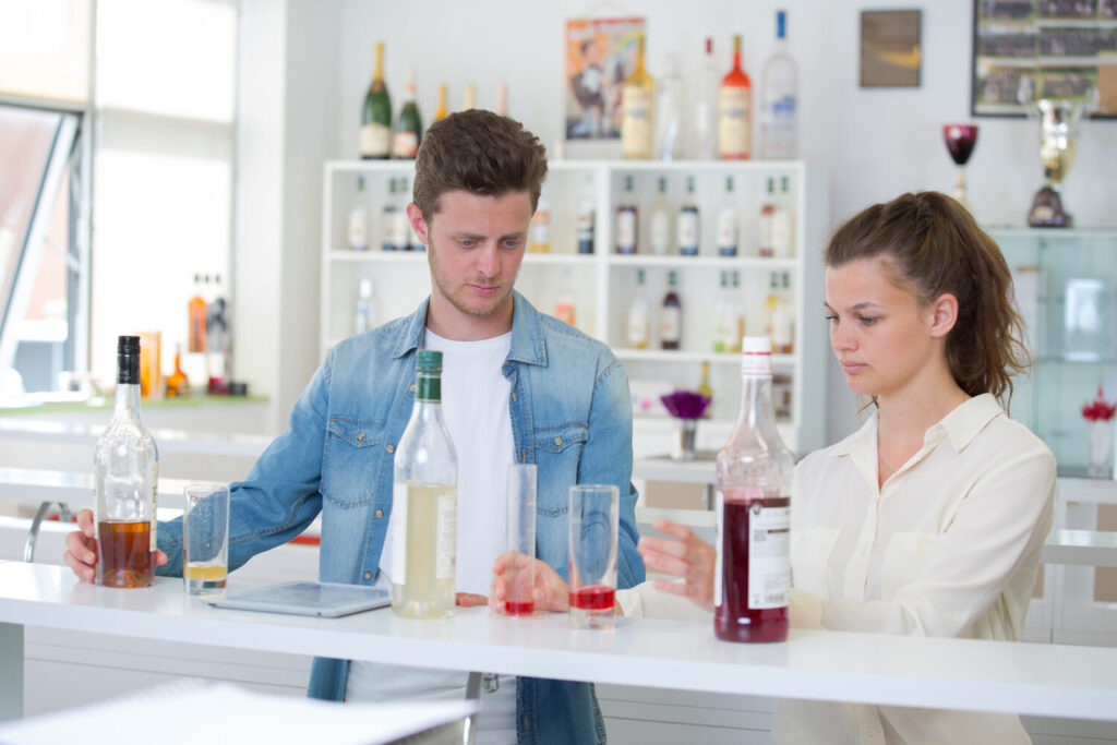 Two students practicing drink measuring during RSA training