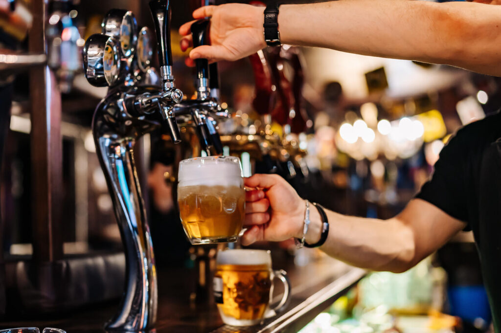 pub staff pouring beer