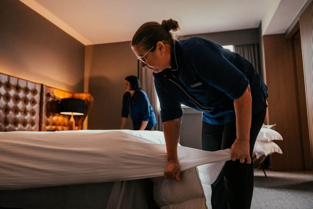 Hotel Housekeeping Staff Making Up a Guest Room