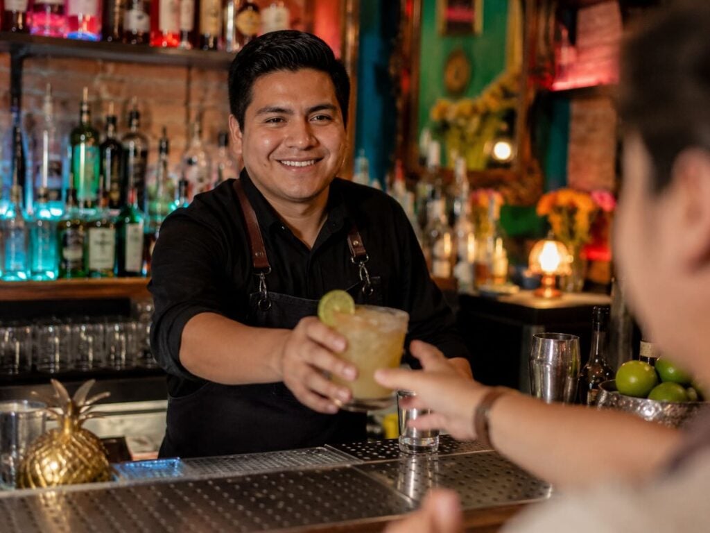 Hospitality worker preparing drinks for service