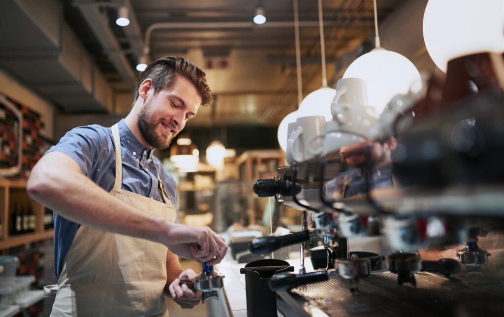 Cropped shot of a handsome young man working in a cafe.